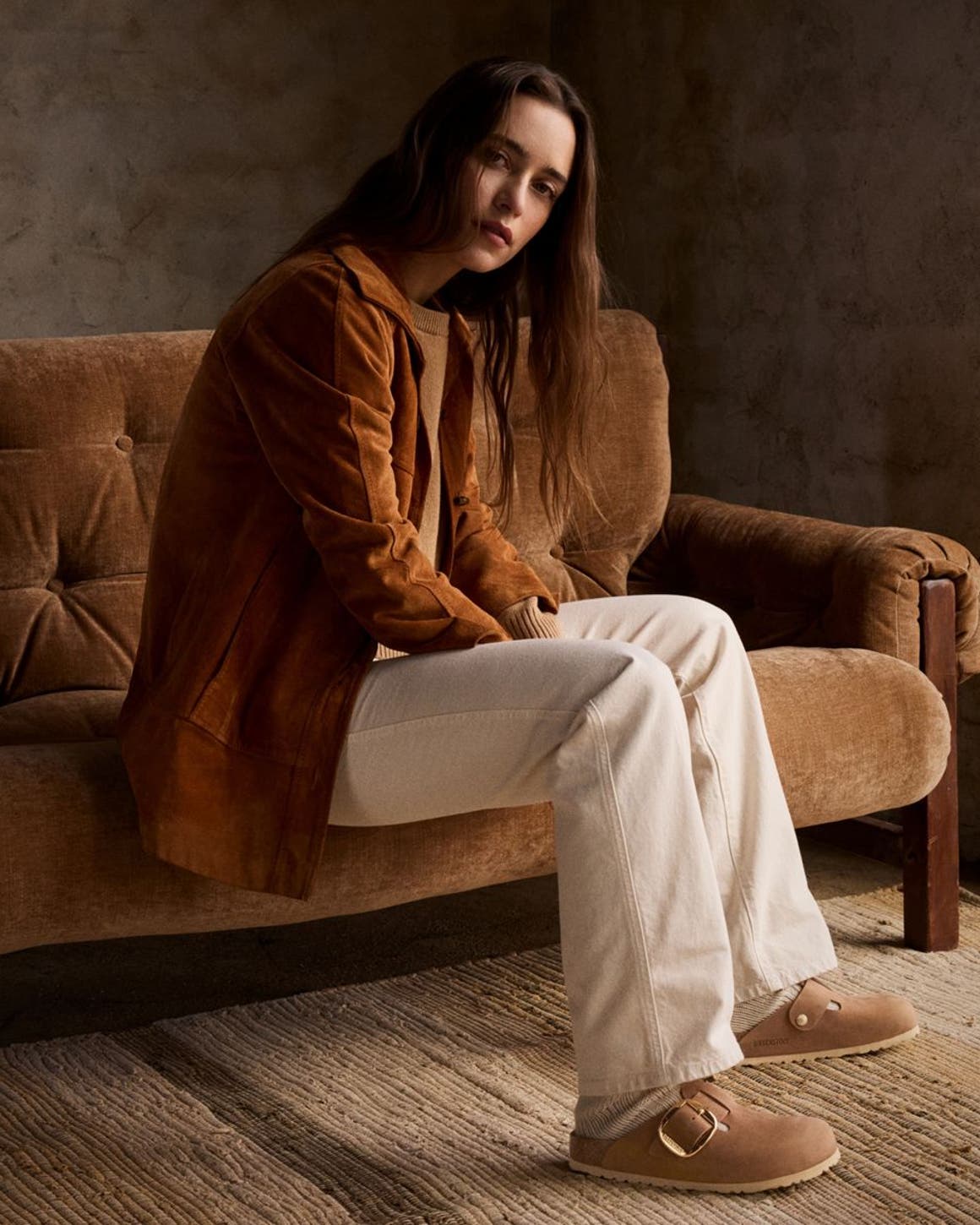 Woman sitting on couch.