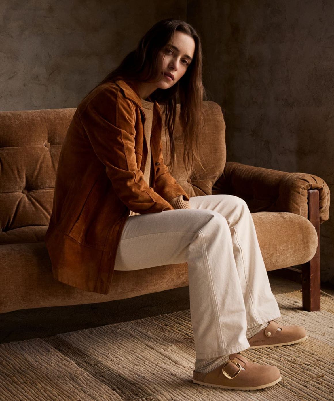 Woman sitting on couch.