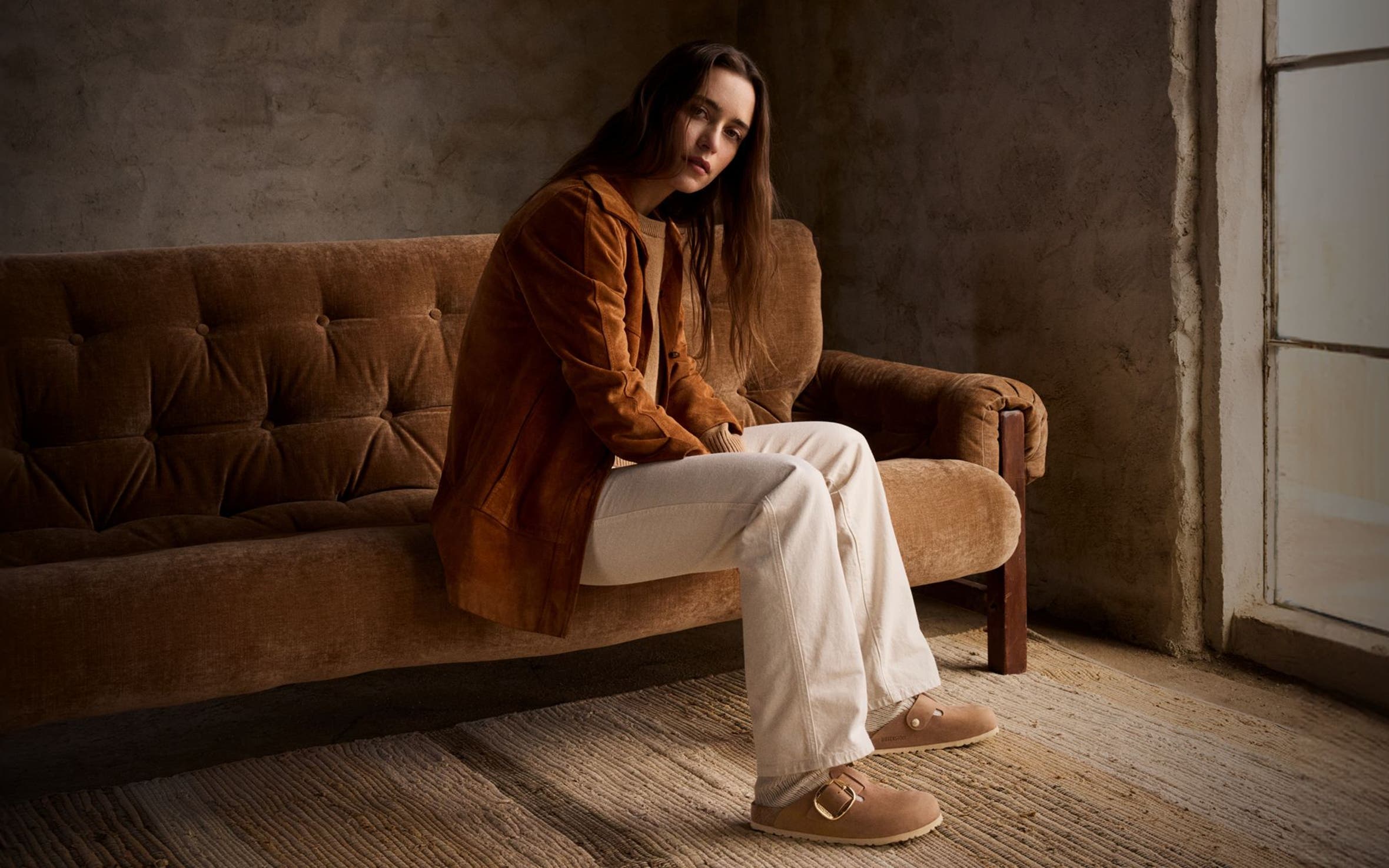 Woman sitting on couch.