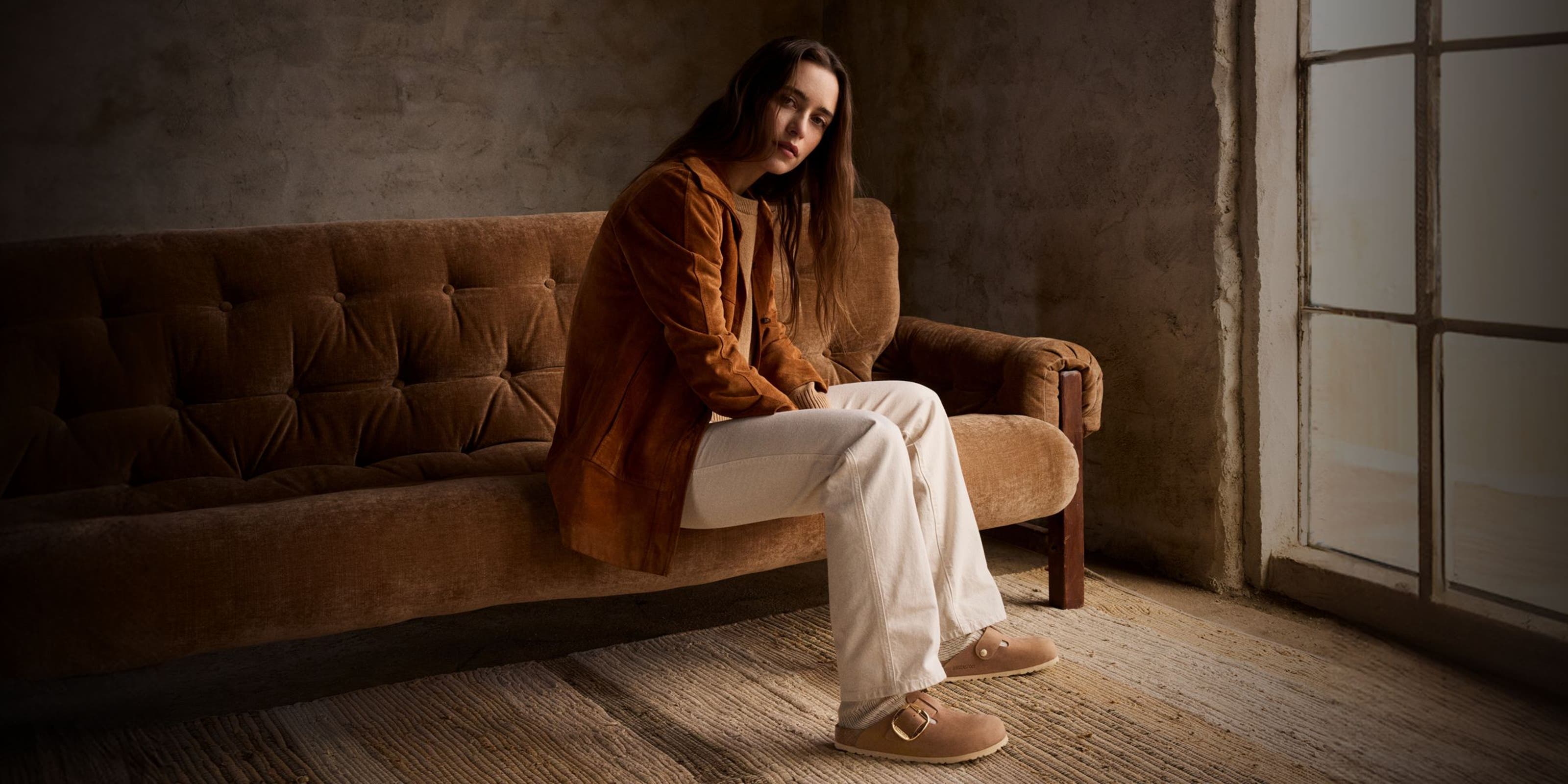 Woman sitting on couch.