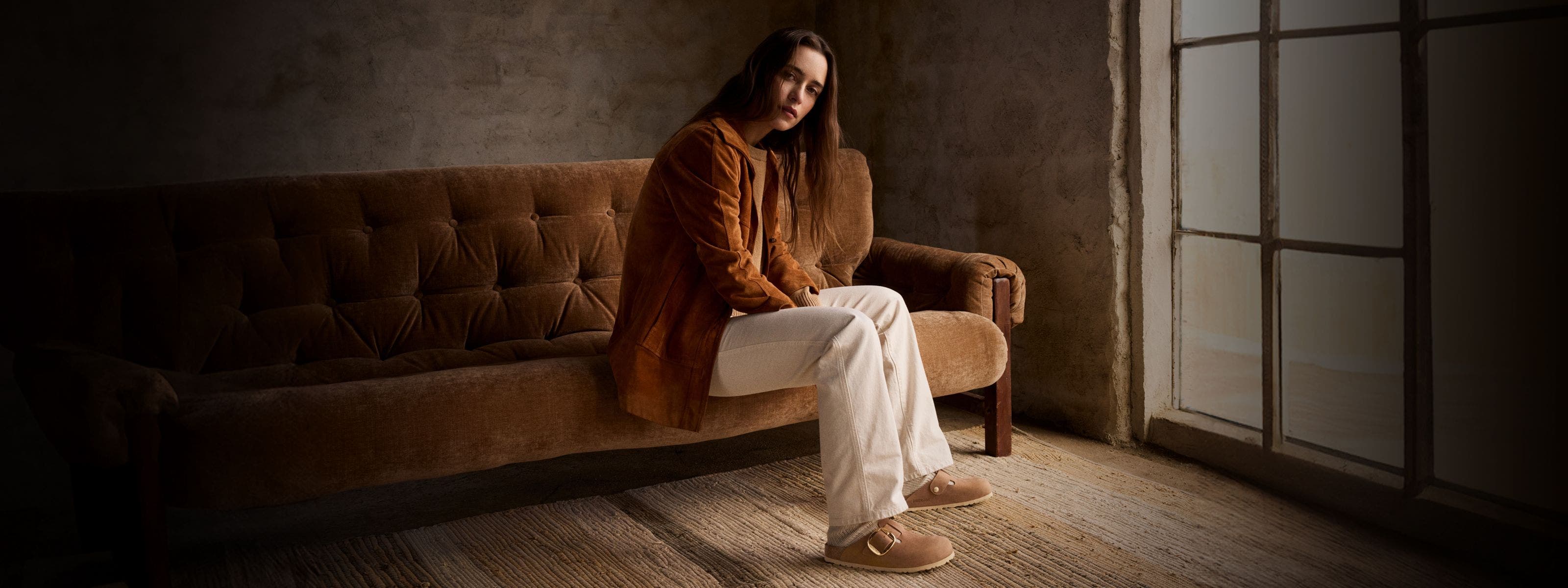 Woman sitting on couch.