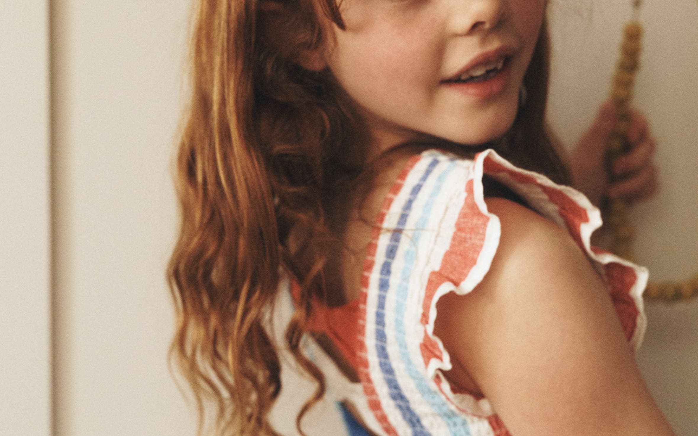 Star-Spangled Summer: A girl in a red, white and blue striped linen sun dress.