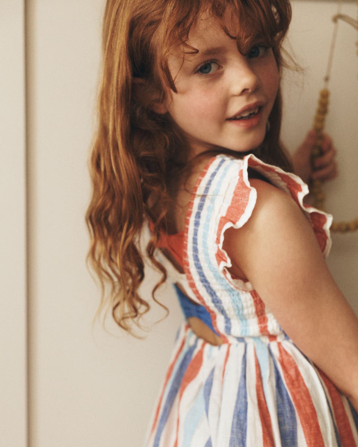 Star-Spangled Summer: A girl in a red, white and blue striped linen sun dress.