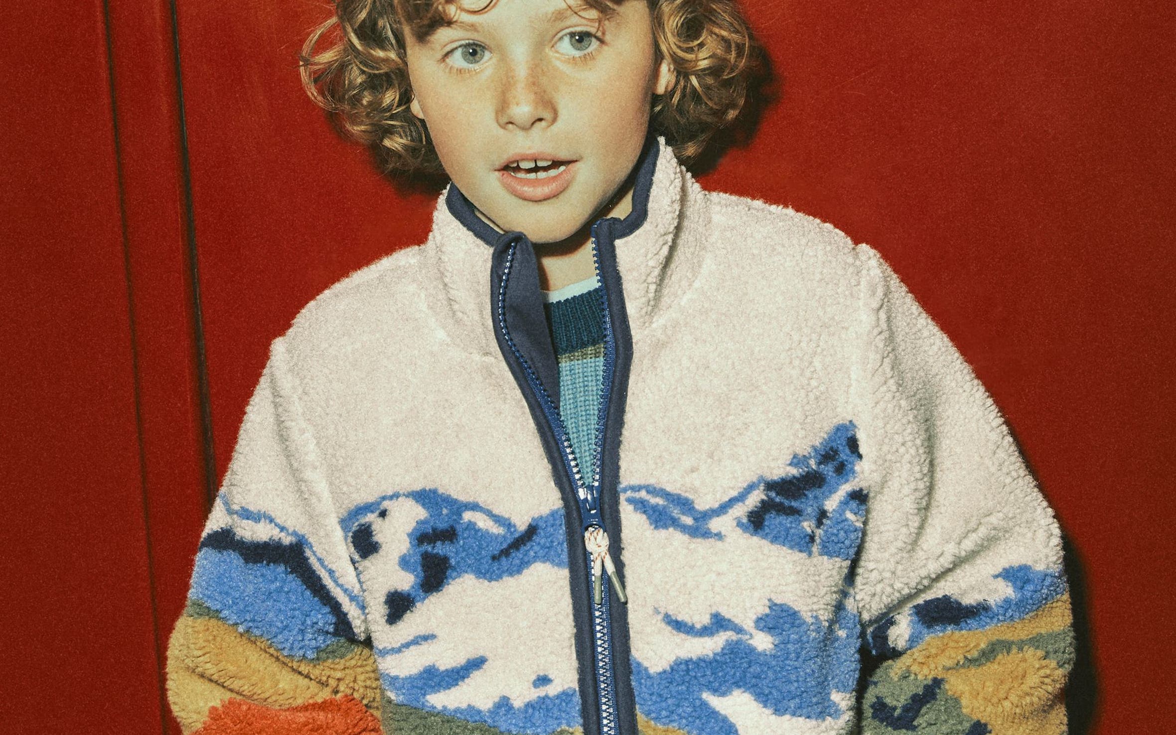 A boy in a Mini Boden sherpa fleece jacket.