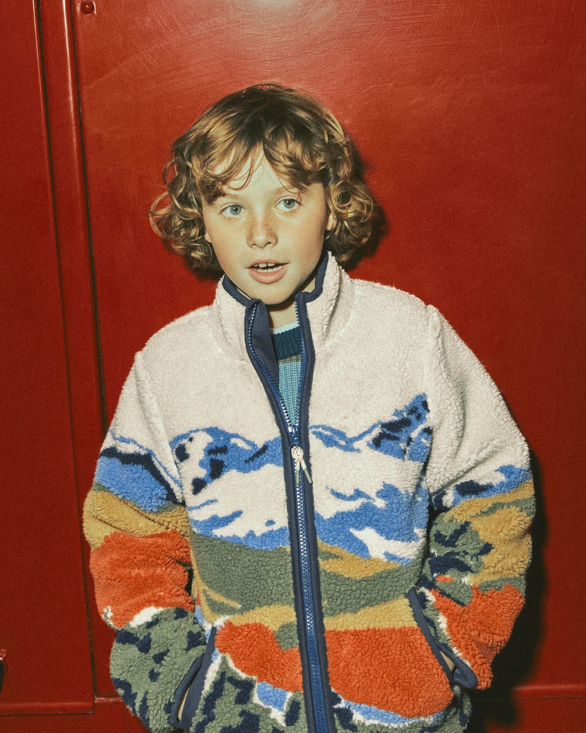 A boy in a Mini Boden sherpa fleece jacket.