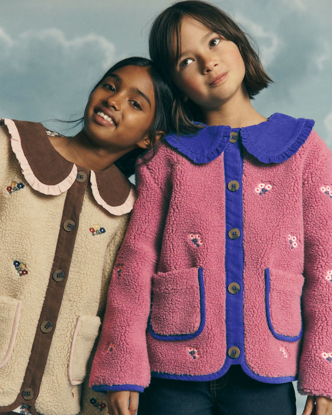 Two girls in Mini Boden sherpa fleece jackets.