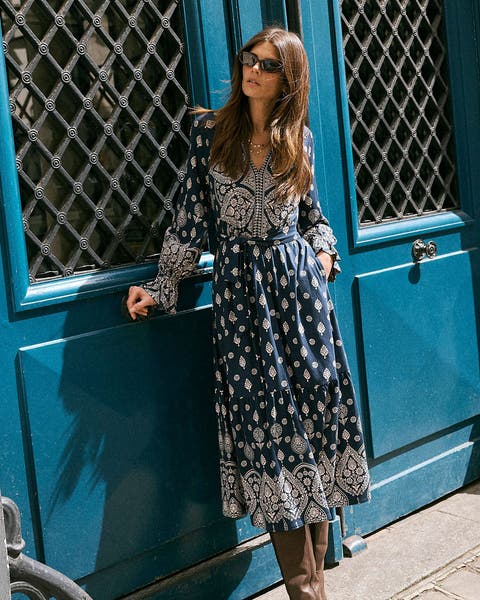 A woman in a printed midi dress.