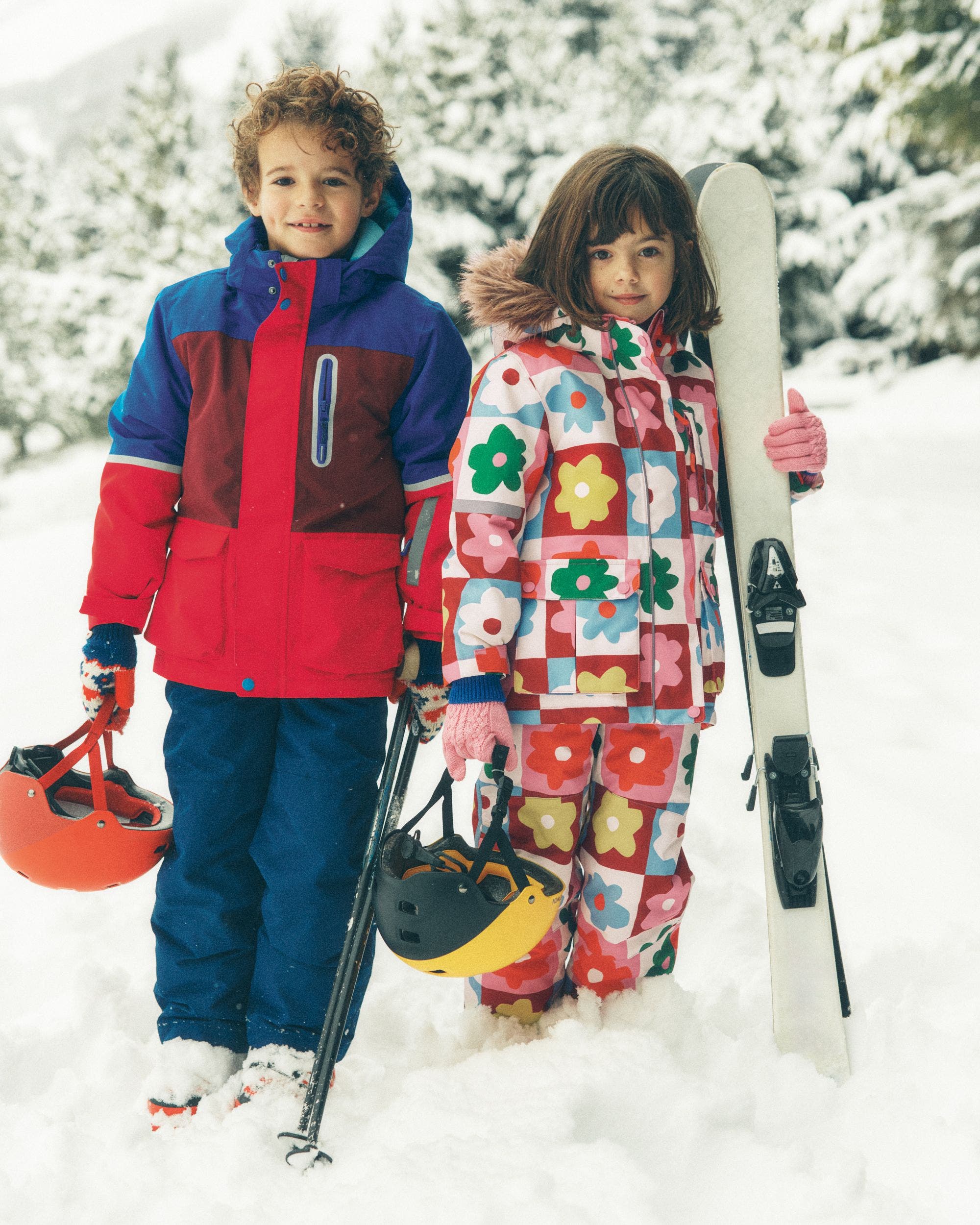 A little boy and little girl wearing outerwear from Mini Boden.