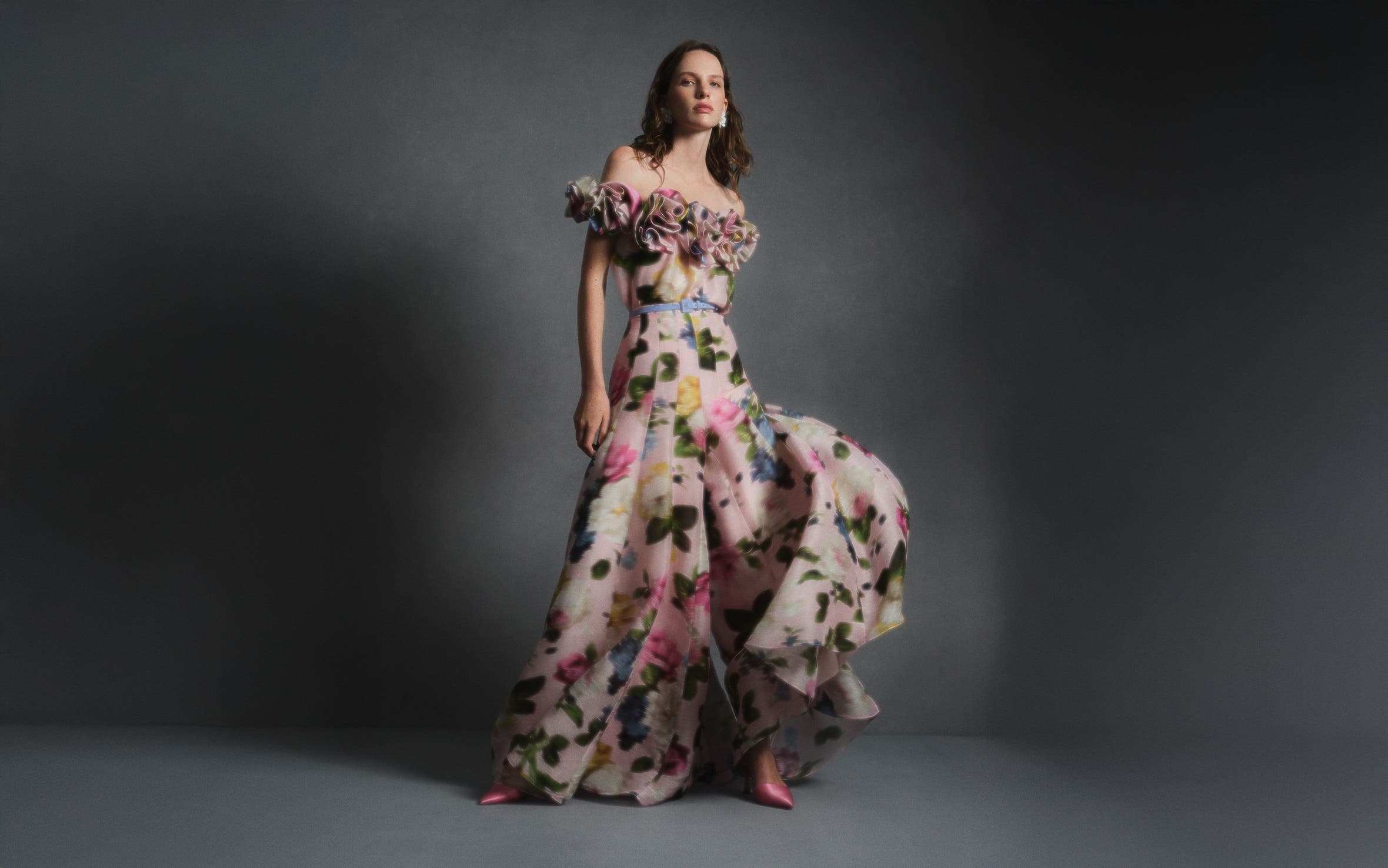 A woman wearing a Carolina Herrera floral-print strapless gown.