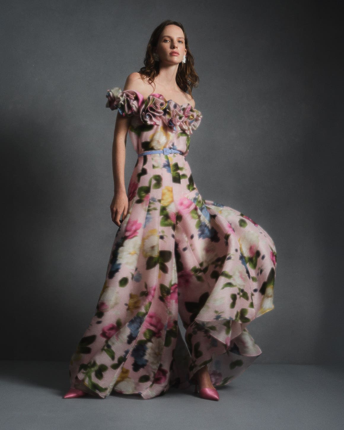 A woman wearing a Carolina Herrera floral-print strapless gown.