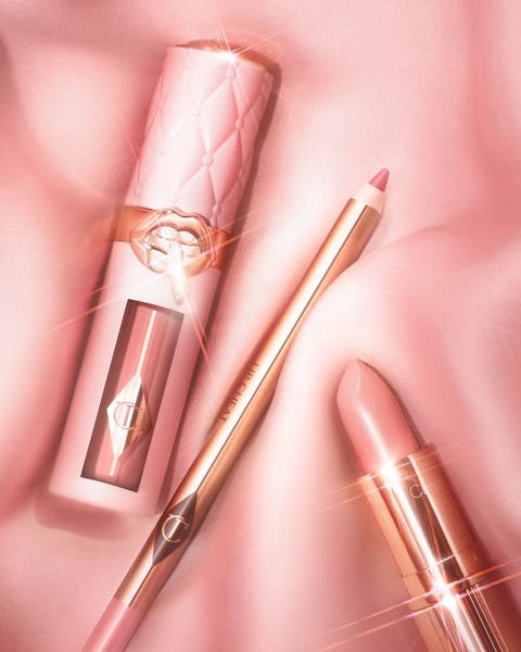 Charlotte Tilbury lip gloss, lip liner and lip stick in a light pink hue.