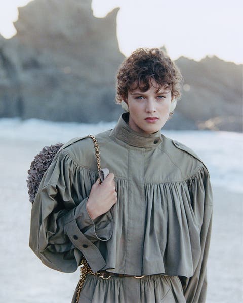 Woman wearing navy green Chloé trench coat.