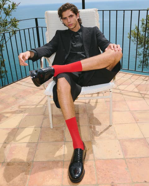 Man wearing Christian Louboutin shoes.