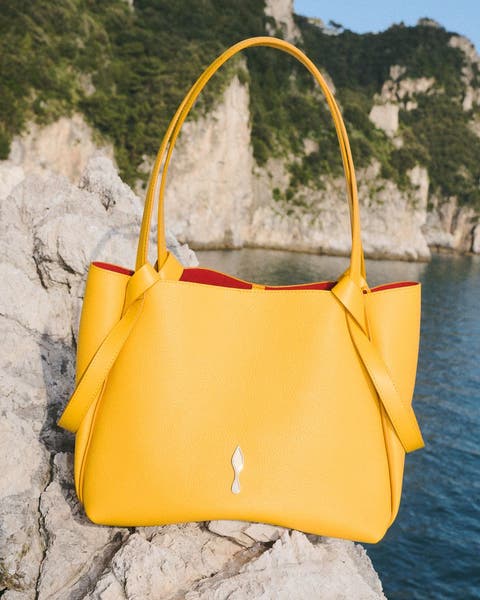 Yellow Christian Louboutin handbag.