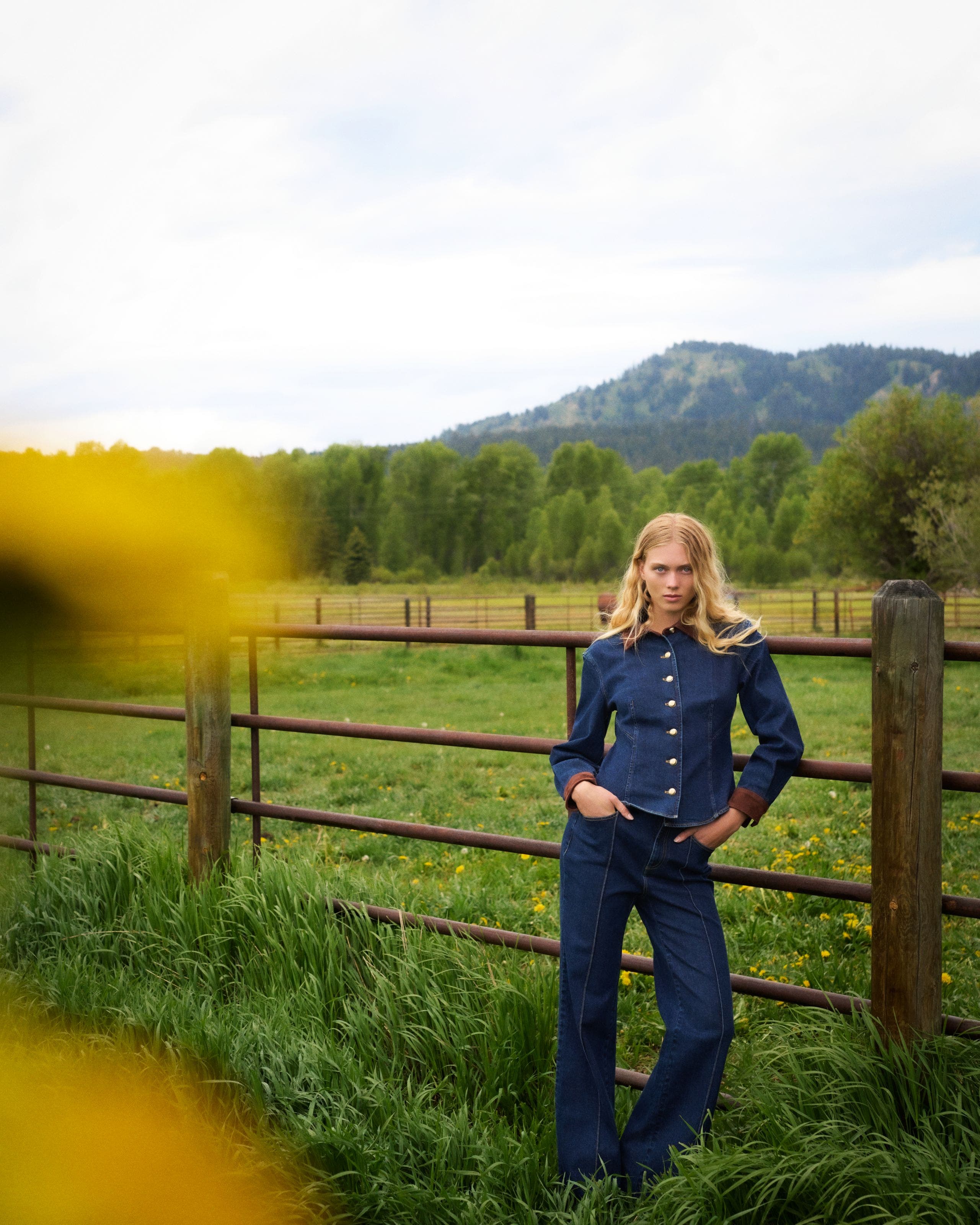 A woman wearing a Cinq à Sept denim top and Cinq à Sept jeans.