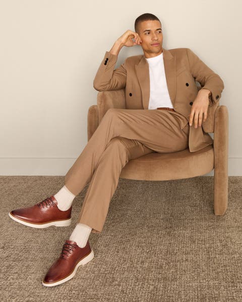 Man wearing light brown suit with Cole Haan Oxfords