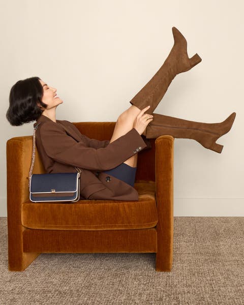 Woman wearing brown blazer and brown Cole Haan boots