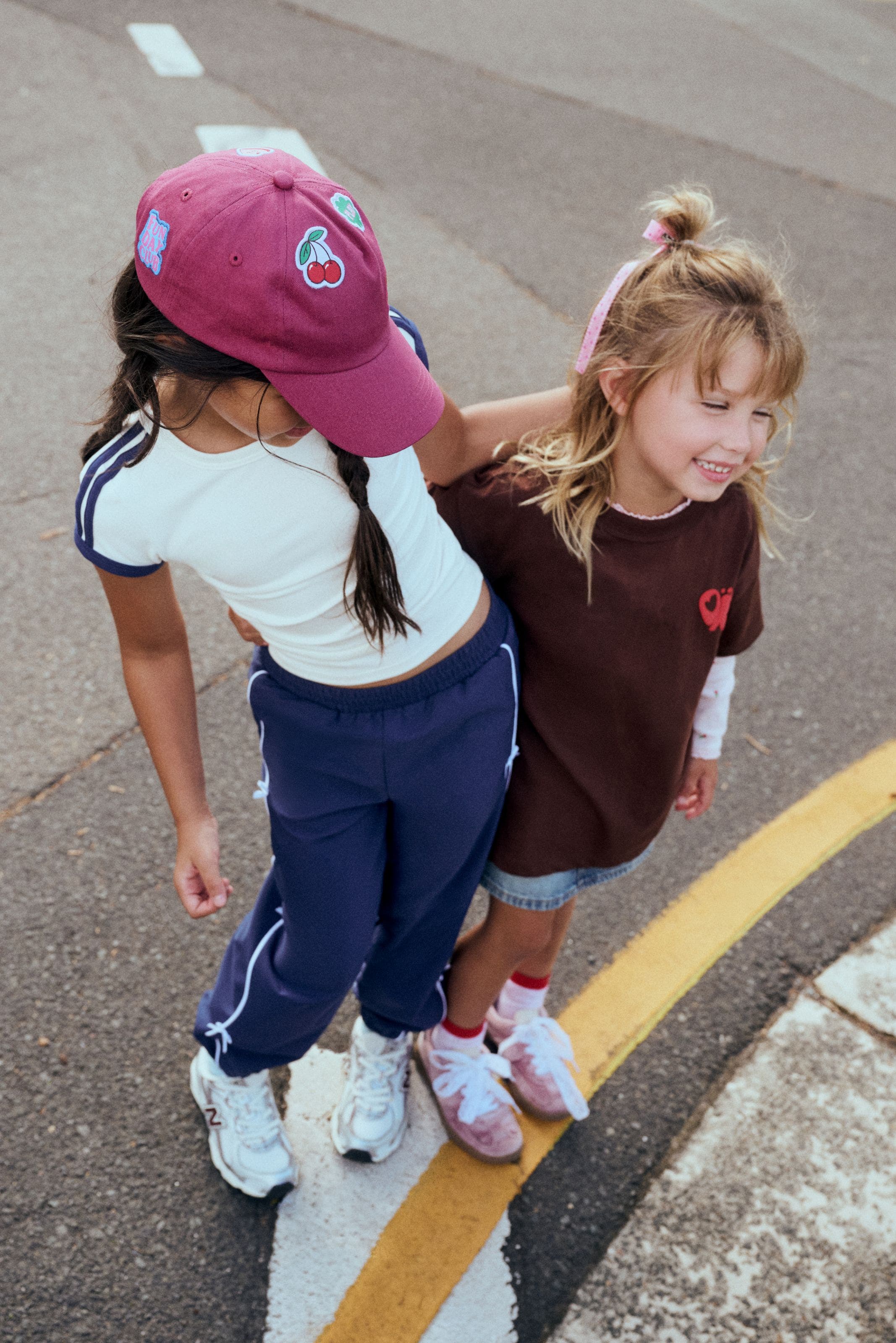 two girls standing on a playground. 