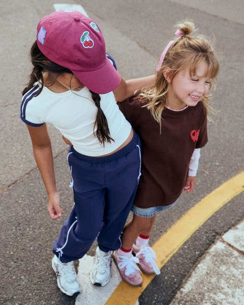 two girls standing on a playground.