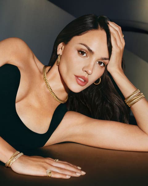 A woman wearing gold chain jewelry.