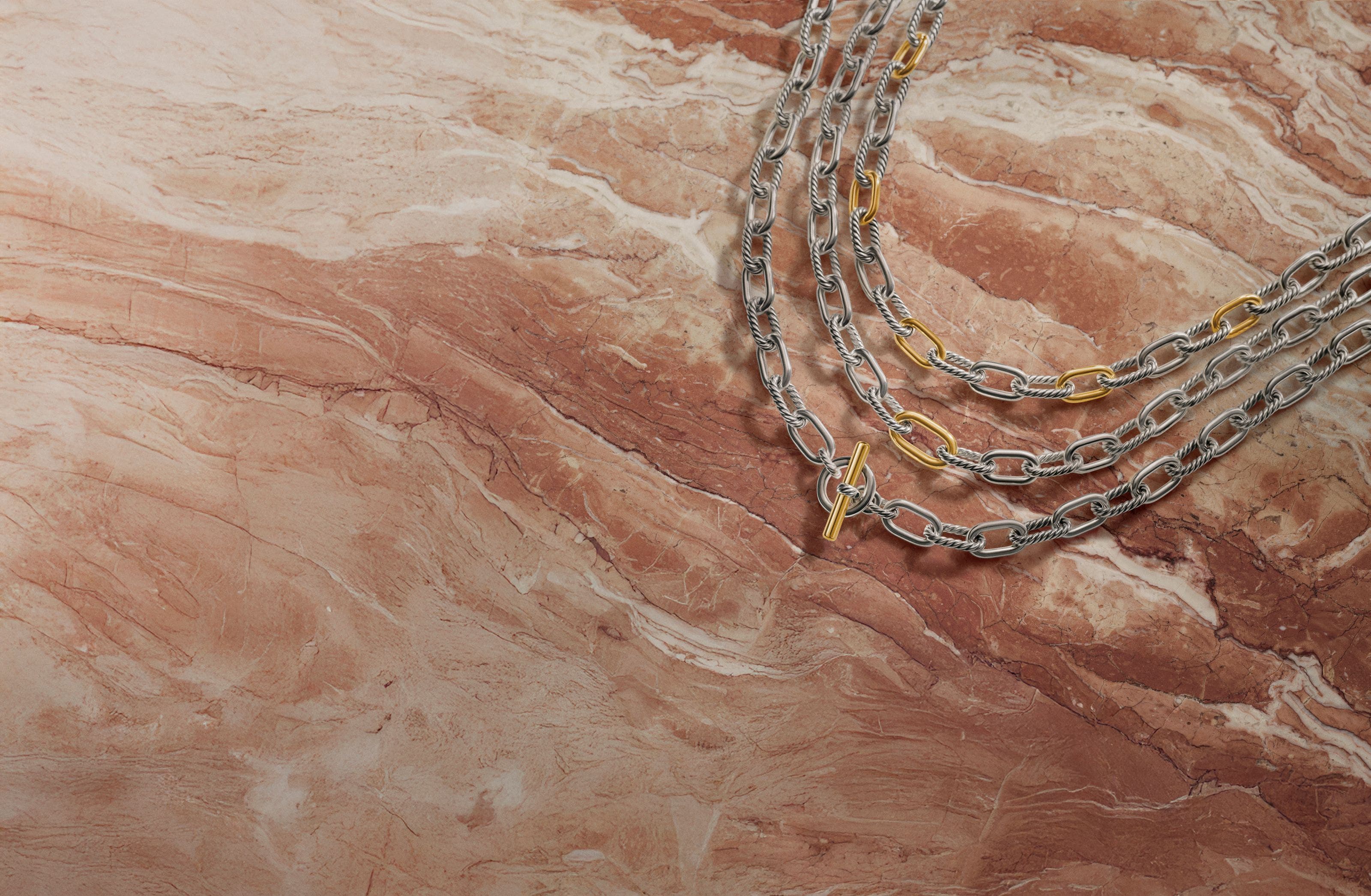 Three chain link silver and gold necklaces. 