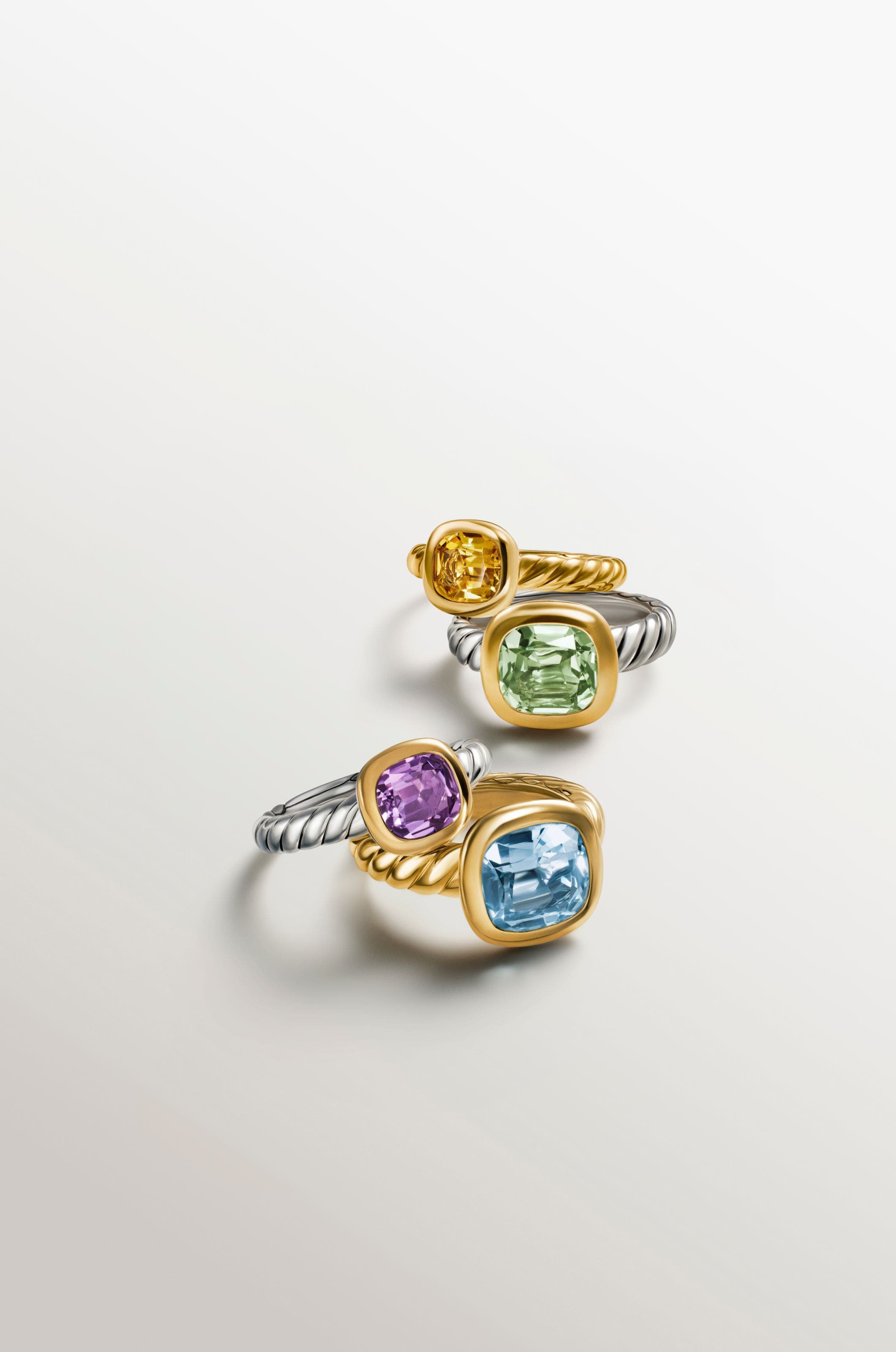 Silver and gold rings with a variety of colorful stones.