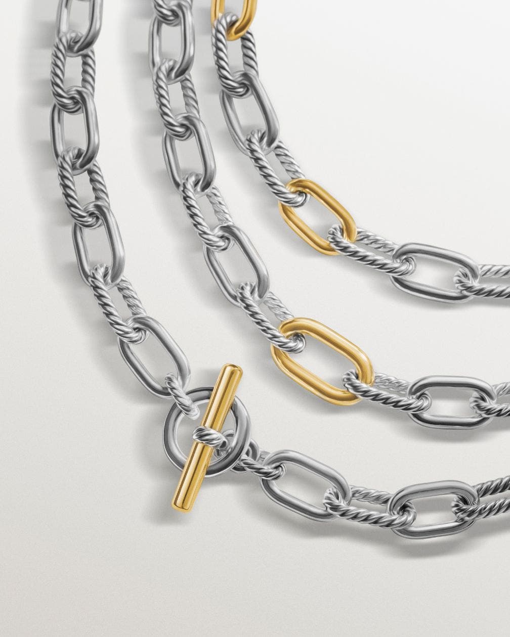 Three chain link silver and gold necklaces. 