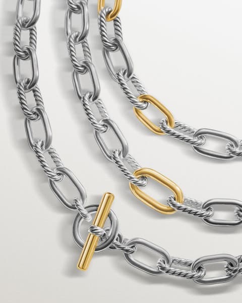 Three chain link silver and gold necklaces.