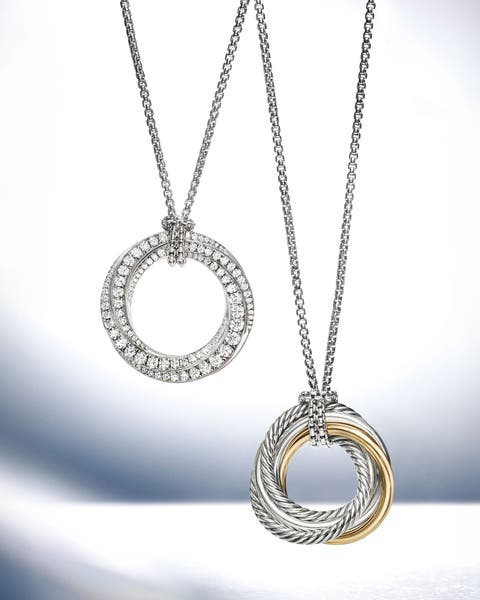 A silver necklace with diamonds and a silver and gold necklace.