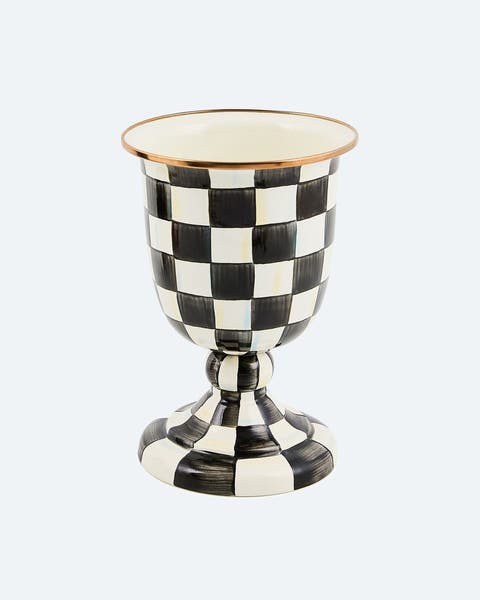 A Mackenzie-Childs Courtly Check black and white hand-painted enamel pedestal urn with a polished copper rim.