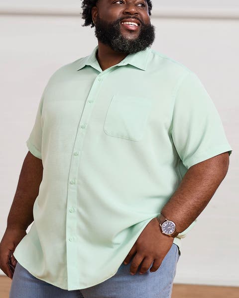 A man wearing light green, short-sleeve shirt.