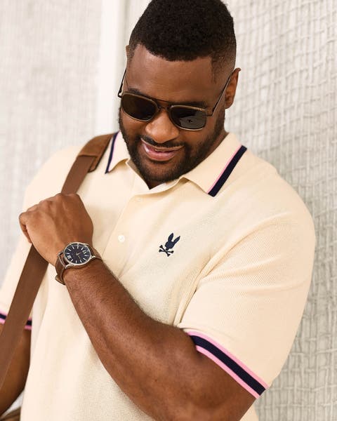 A man wearing a Psycho Bunny polo and sunglasses.