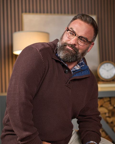A man wearing a polo-neck sweater.