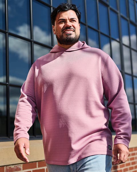 A man wearing a lilac-colored hoodie.