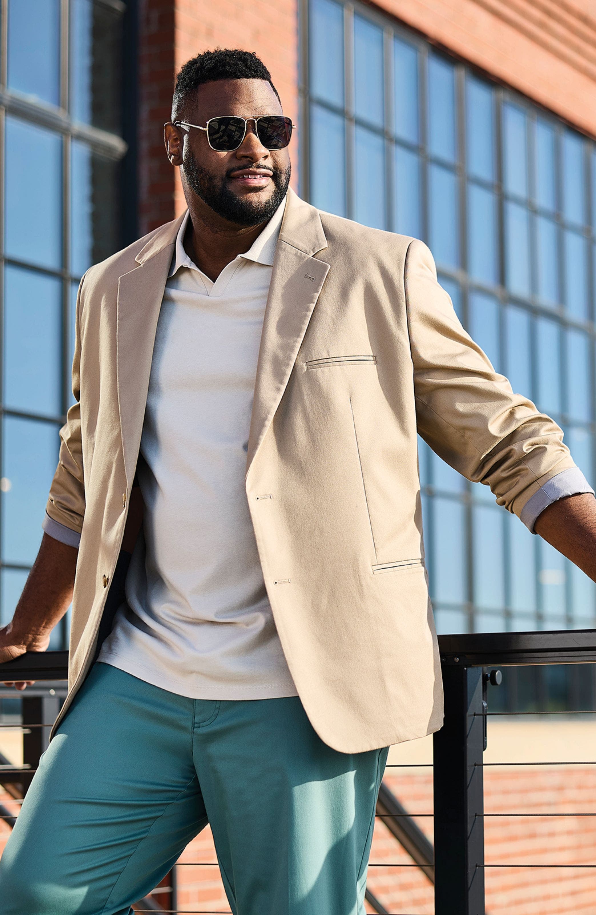 A man wearing a cream-colored sport coat.
