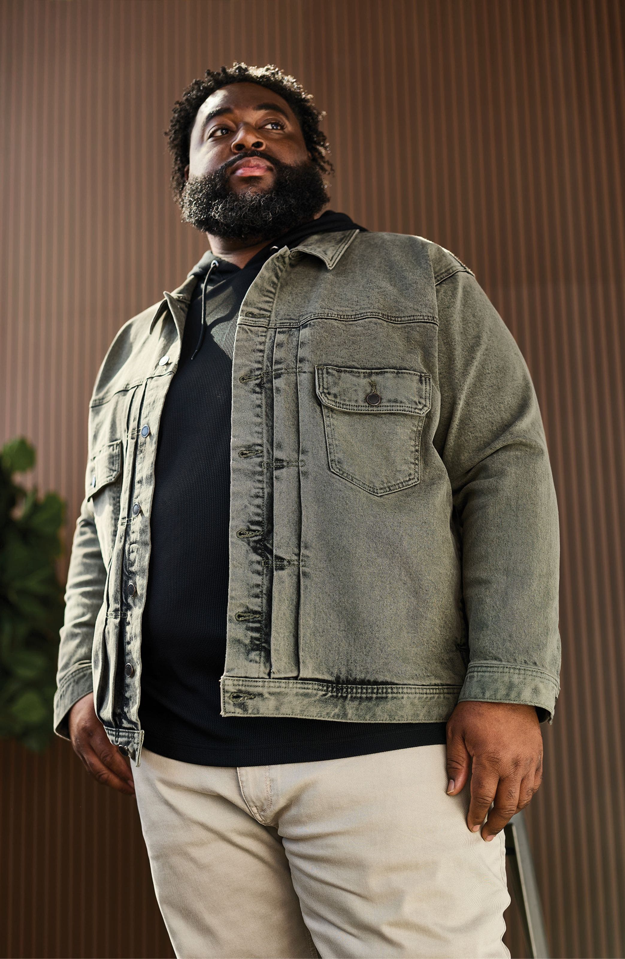A man wearing a faded denim jacket.