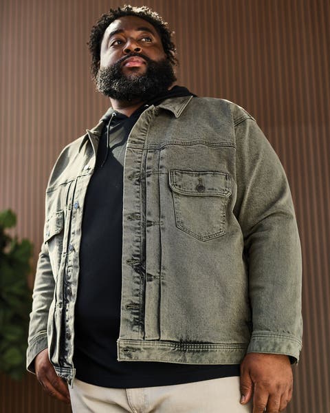 A man wearing a faded denim jacket.