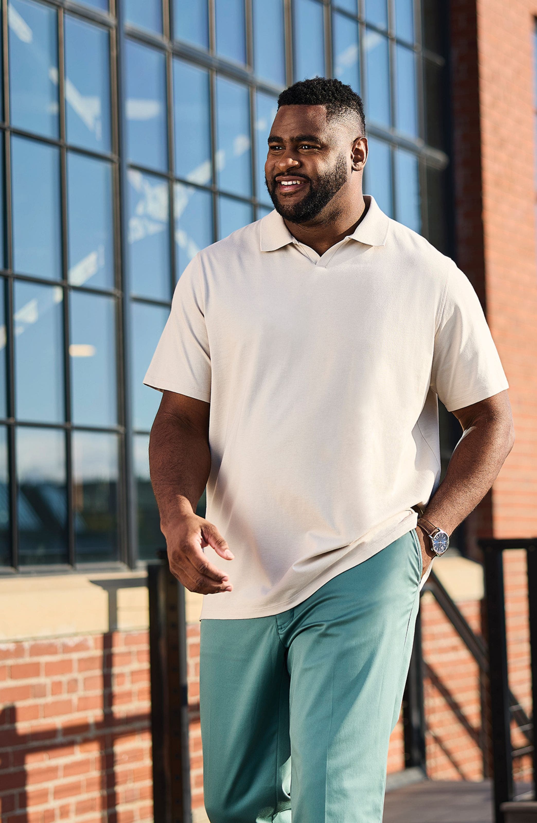 A man wearing a cream-colored polo.