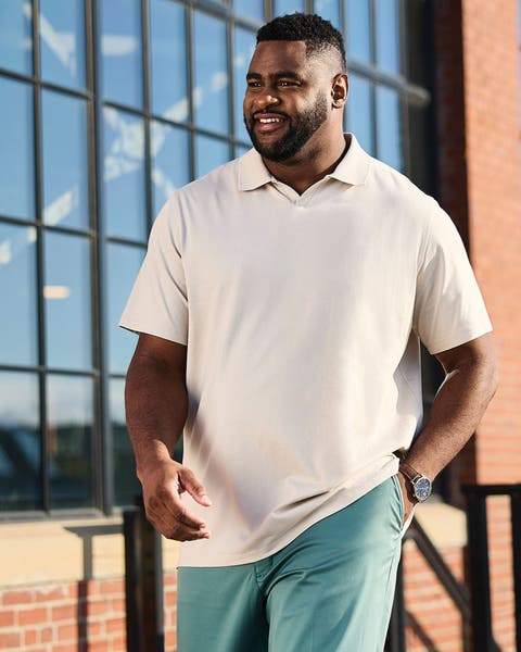 A man wearing a cream-colored polo.