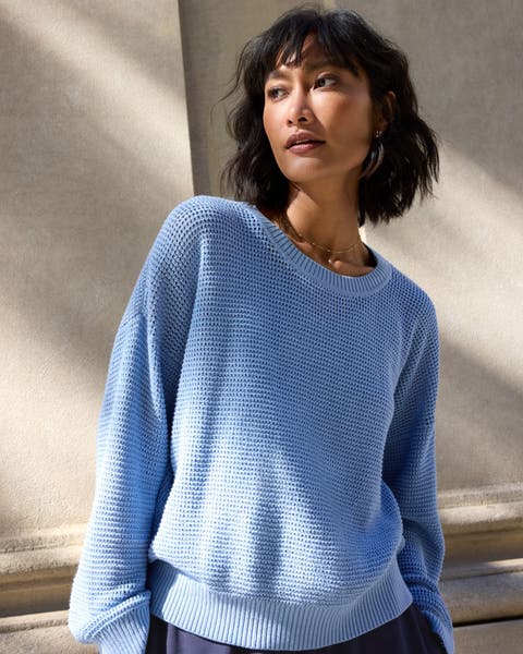 Woman wearing blue lightweight cotton sweater.