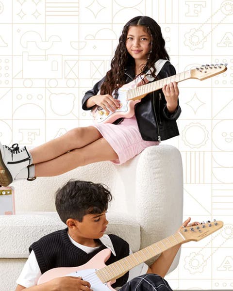 A boy and girl playing guitars.