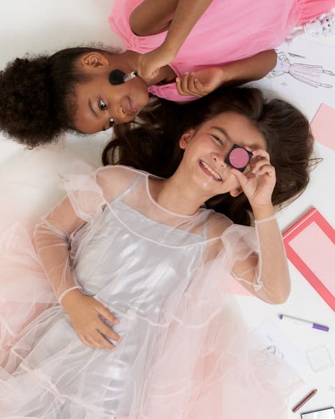 Two girls playing dress up.