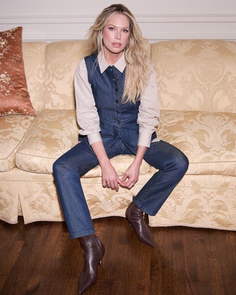 A woman wearing brown pointed-toe boots.