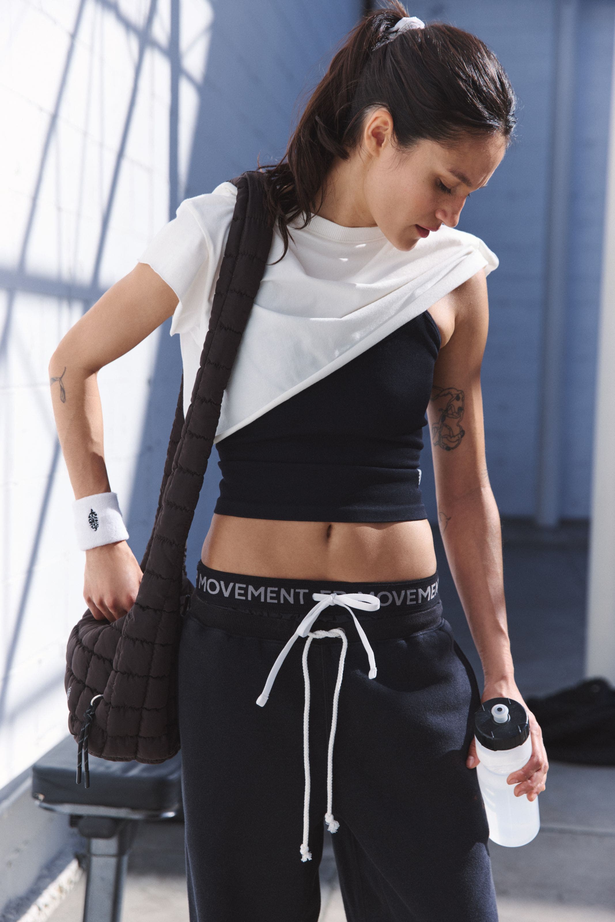 A women wearing a workout shirt over a workout tank.