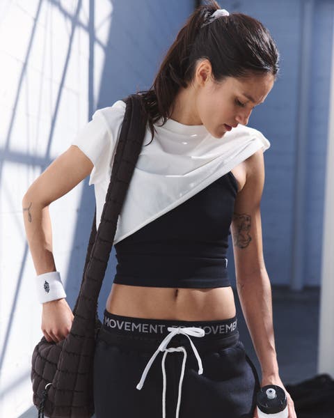 A women wearing a workout shirt over a workout tank.