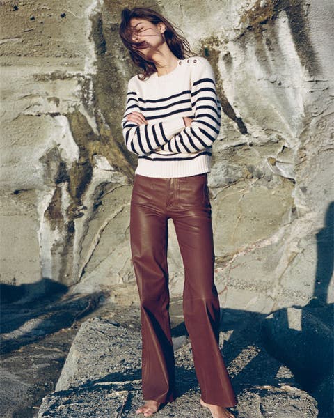 Woman wearing leather FRAME pants and a striped sweater.