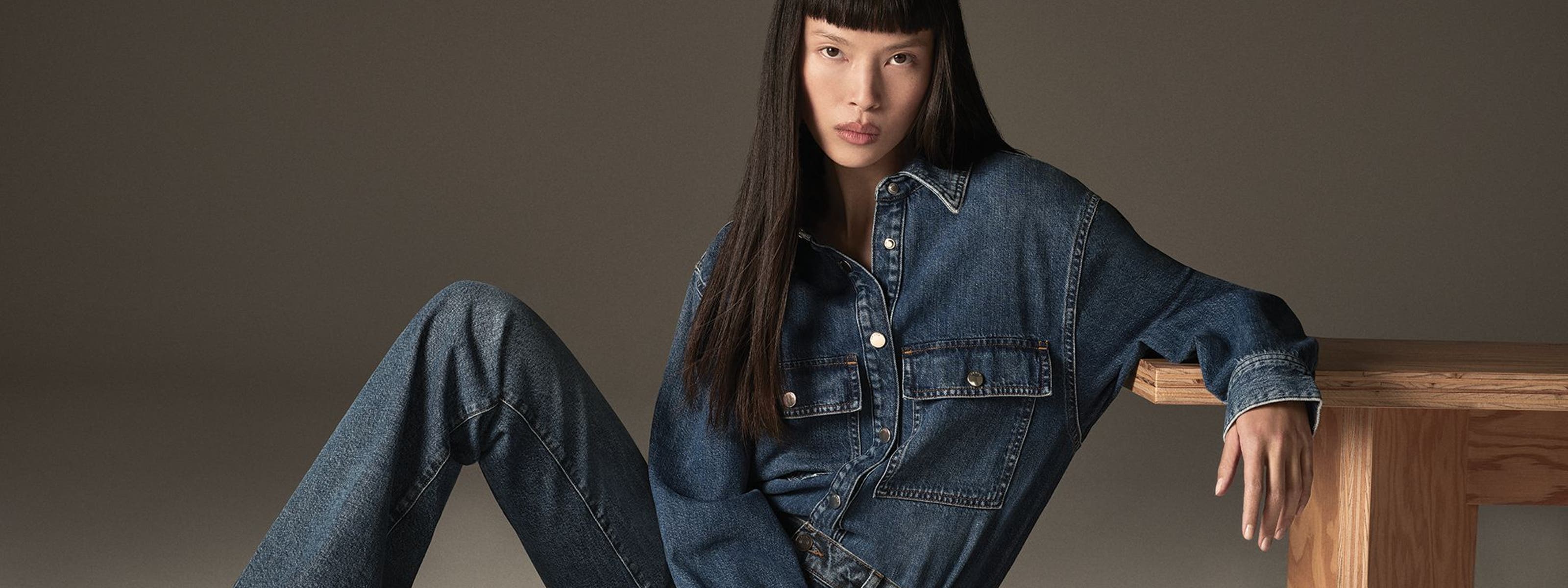 Woman wearing long sleeve denim shirt and denim jeans from FRAME.