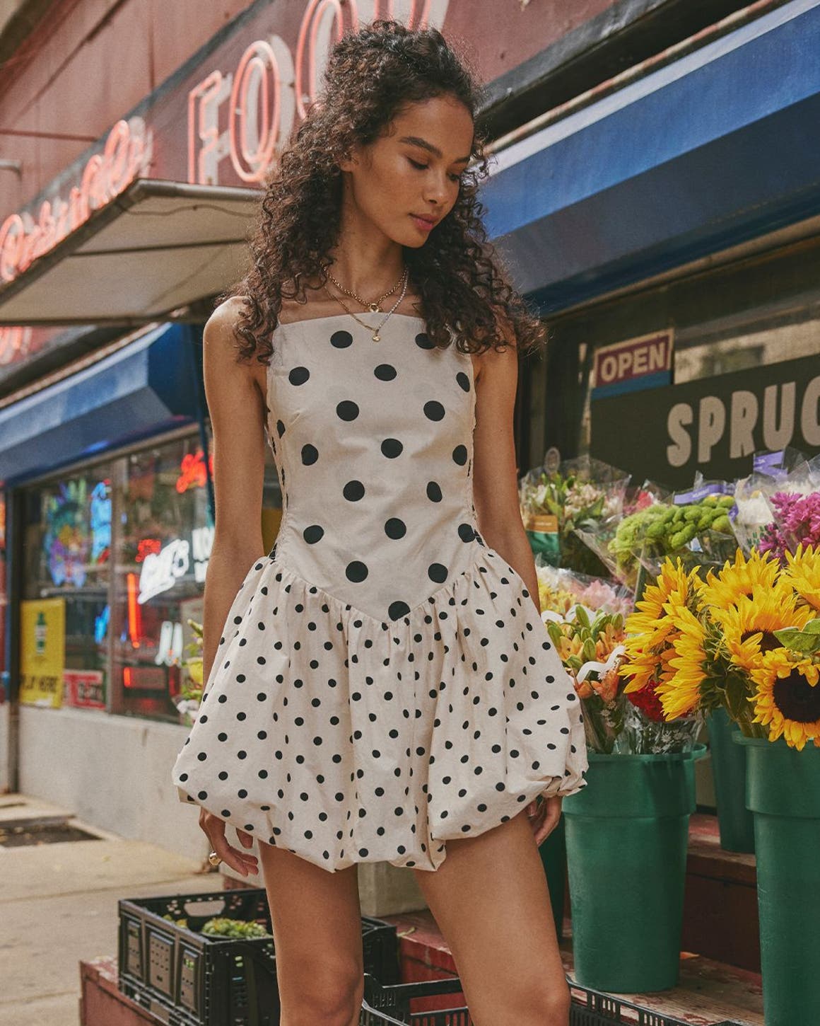 A woman wearing a polka dot bubble-hem minidress.