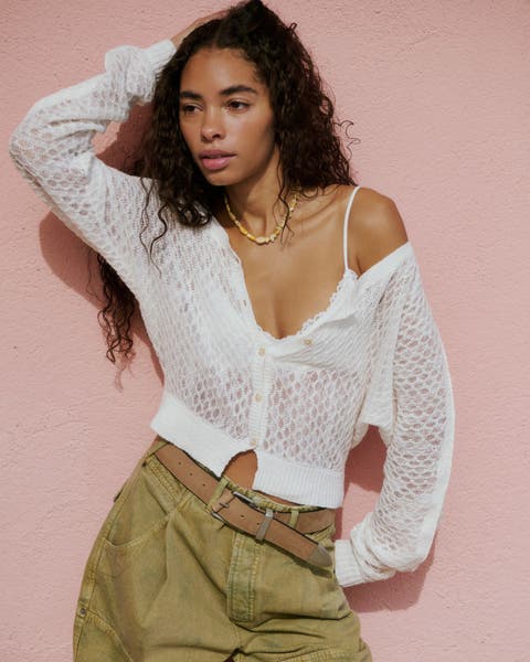 Woman wearing white lightweight cardigan sweater.