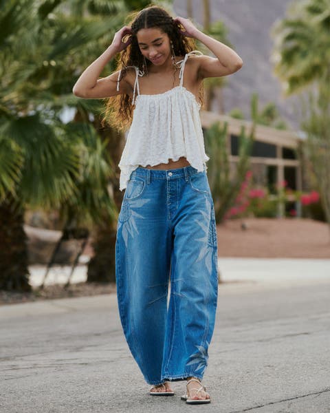 Woman wearing We The Free denim and white top.